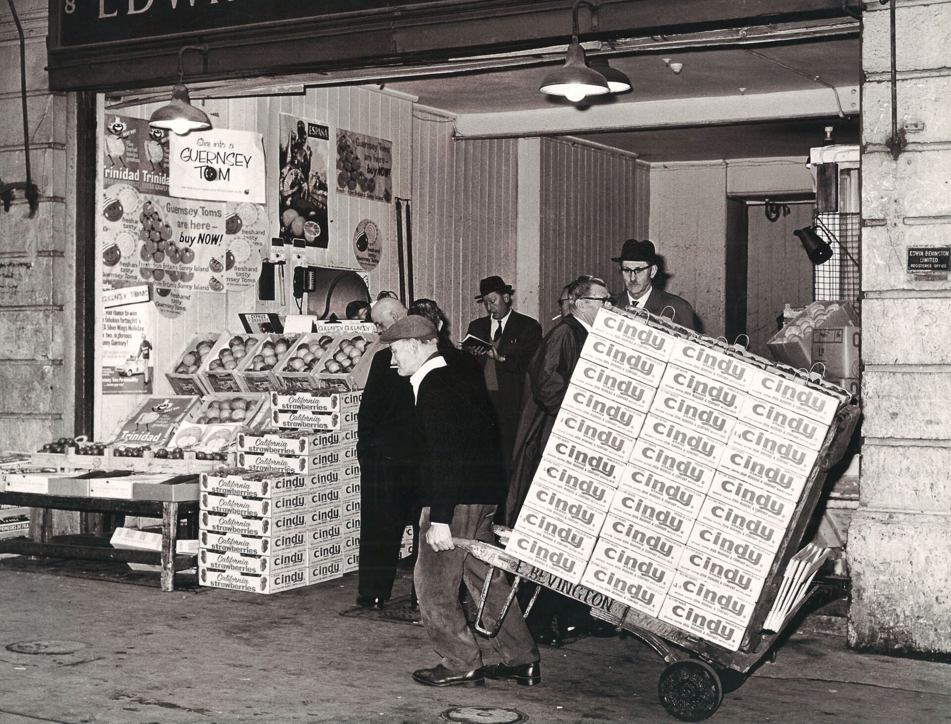 Griffin and Brand - Black-and-white photograph of people with produce crates in a packing facility - Home, About Us